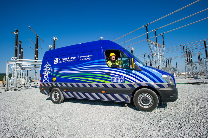 Transmission vehicle An SSEN Transmission employee in PPE at the wheel of an SSEN Transmission vehicle surrounded by substation infrastructure.