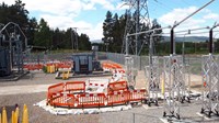 A substation with construction barriers forming a line from one piece of infrastructure to another.
