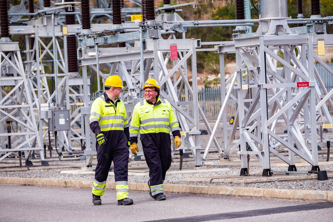 Image of two SSEN Transmission employees walking in a substation