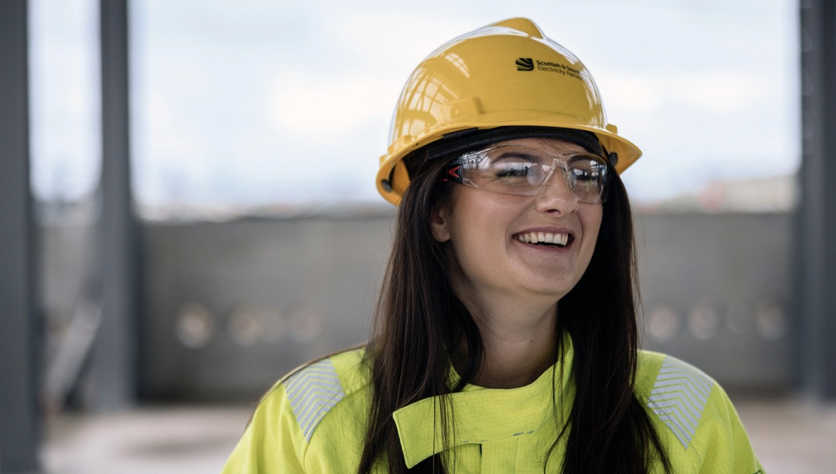 An image of an SSEN Transmission onsite employee wearing yellow PPE, a yellow hardhat, and a pair of protective goggles