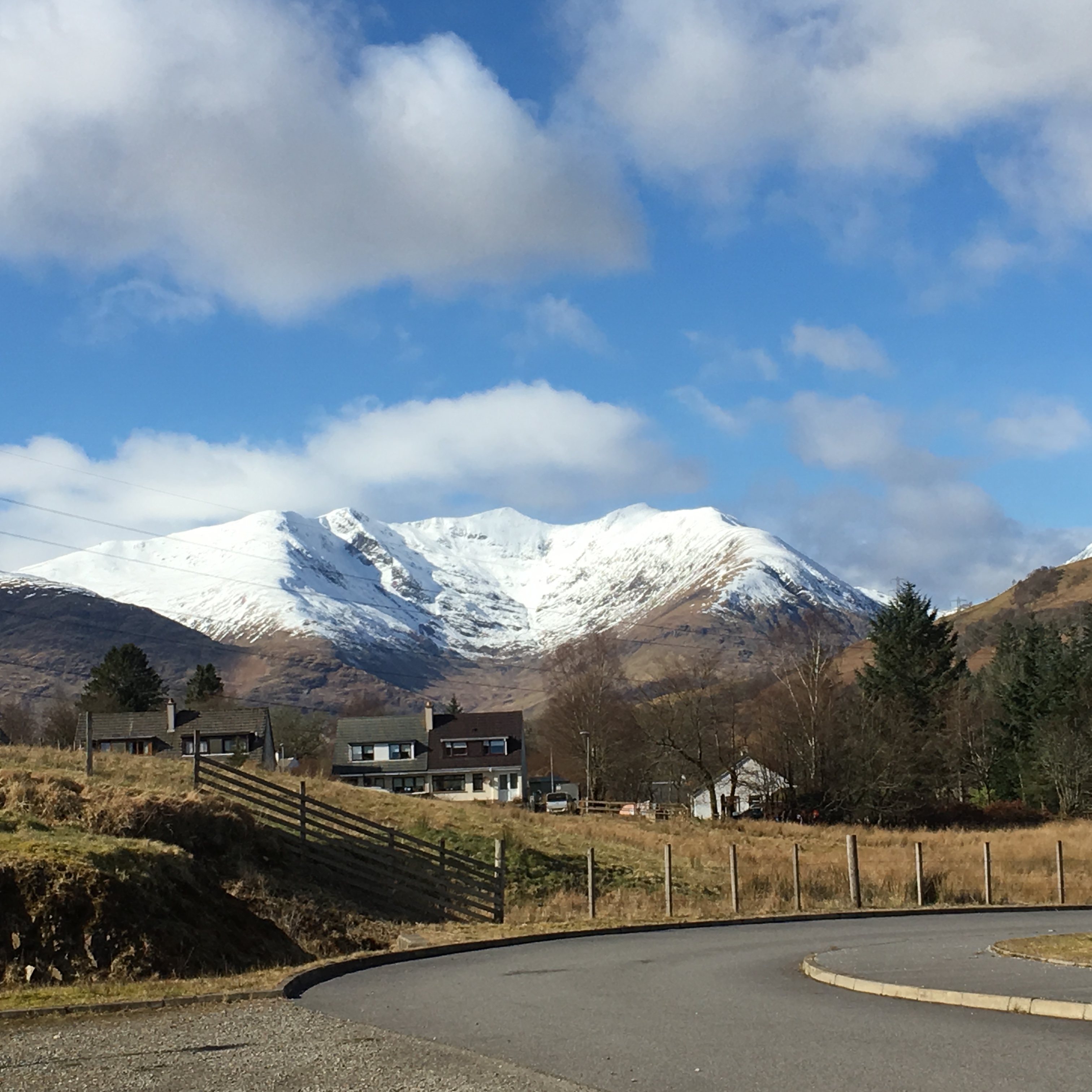 Scenic view of houses and snow capped mountain