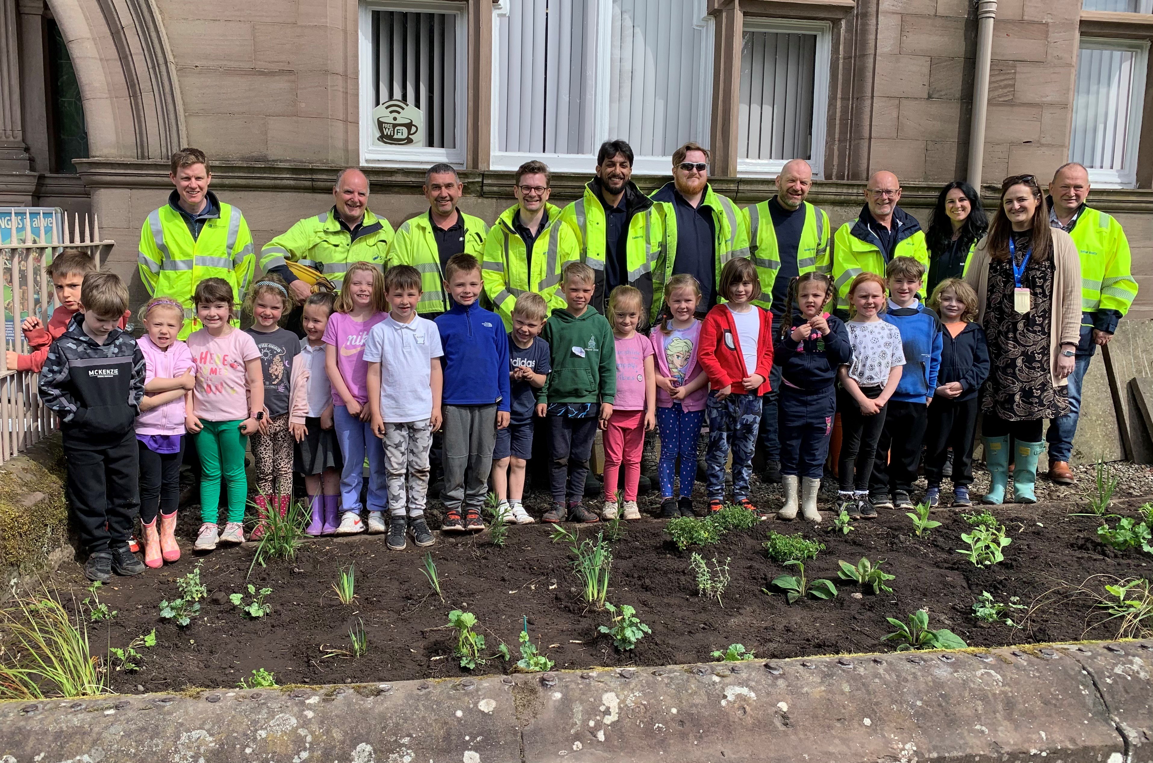 1. SSEN Transmission_Volunteers from SSEN Transmission and Balfour Beatty with Andover Primary School pupils at the Brechin Bee Bed.jpg