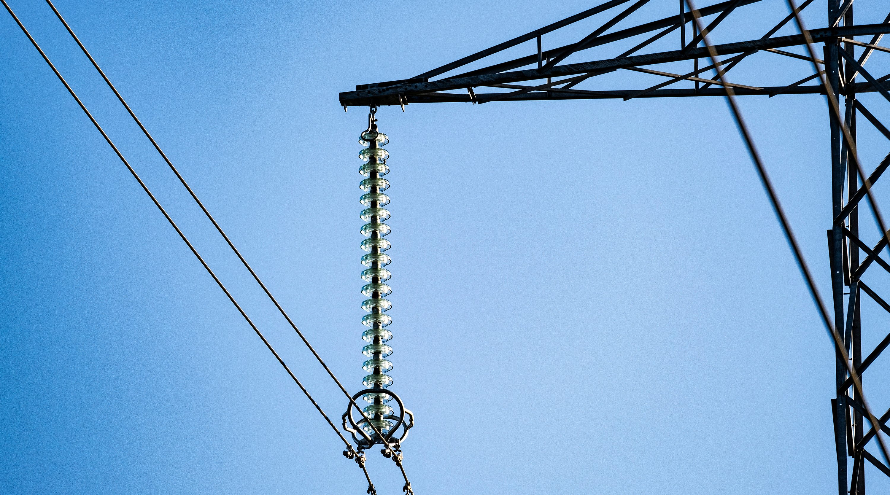 Image of transmission infrastructure against a blue sky 